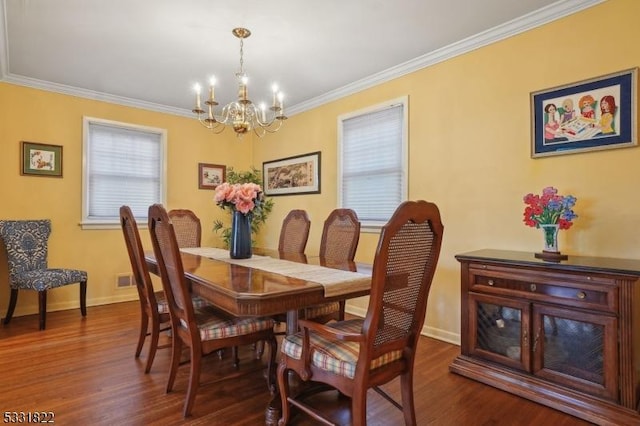 dining space with a notable chandelier, ornamental molding, and dark hardwood / wood-style floors