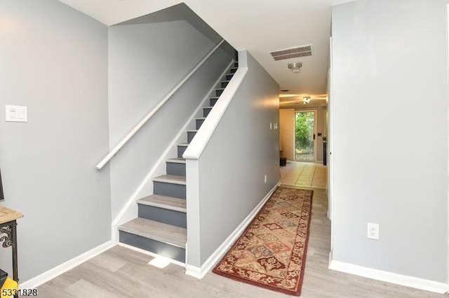 staircase featuring hardwood / wood-style flooring