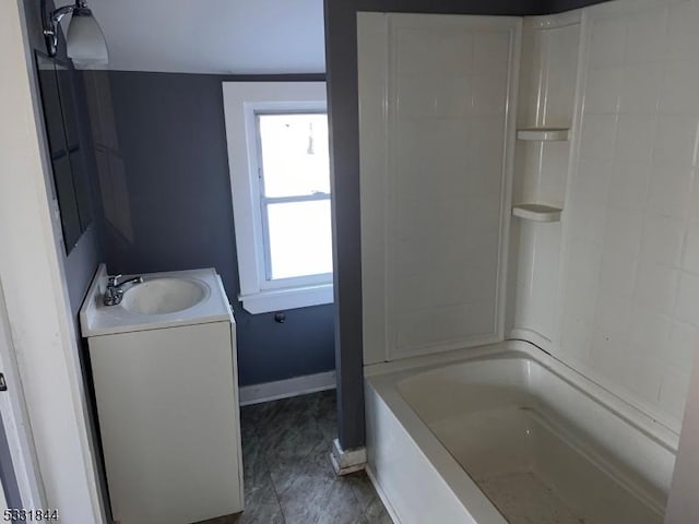 bathroom featuring plenty of natural light, shower / bathtub combination, and vanity