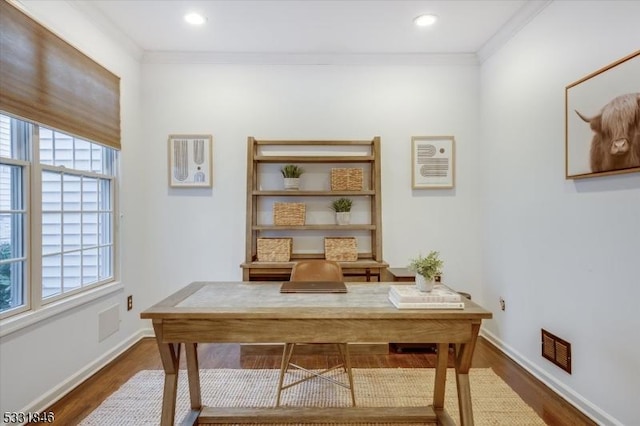 office space featuring a wealth of natural light, dark hardwood / wood-style floors, and crown molding