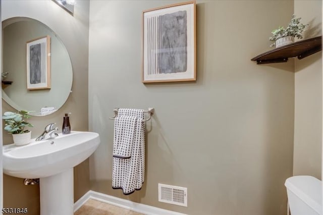 bathroom featuring sink and toilet