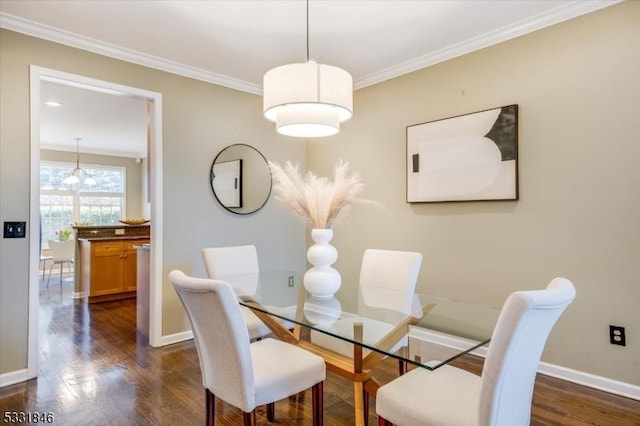 dining room featuring ornamental molding, a chandelier, and dark hardwood / wood-style floors