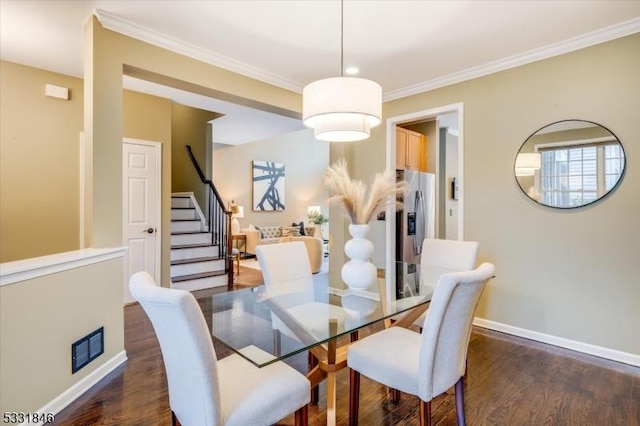 dining space featuring dark hardwood / wood-style floors and ornamental molding