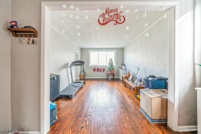 workout room with crown molding and dark hardwood / wood-style floors