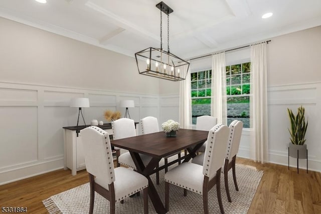 dining space featuring beam ceiling, coffered ceiling, and hardwood / wood-style flooring