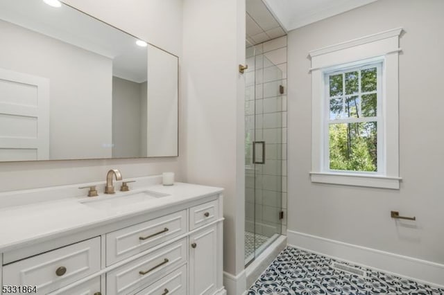 bathroom featuring a shower with shower door, vanity, tile patterned floors, and ornamental molding