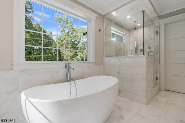 bathroom with independent shower and bath, tile walls, and crown molding