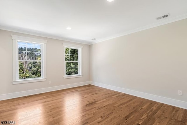 unfurnished room with hardwood / wood-style floors and crown molding