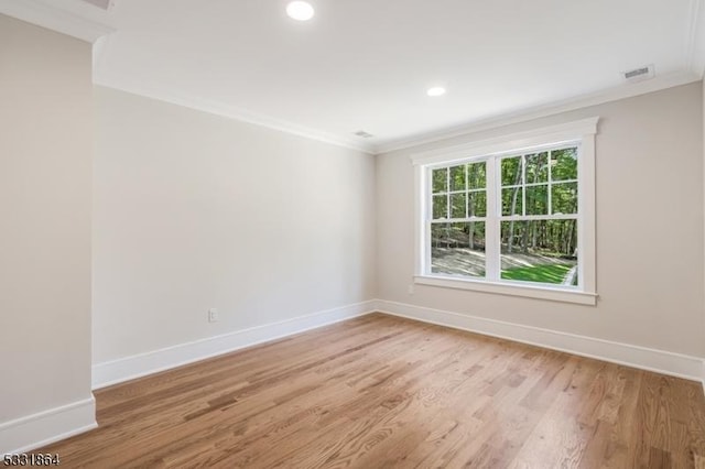 unfurnished room with crown molding and light hardwood / wood-style flooring