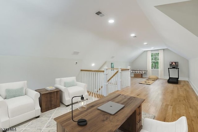 living room with lofted ceiling and light wood-type flooring