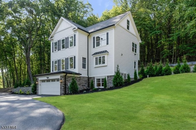 view of front facade featuring a front lawn and a garage