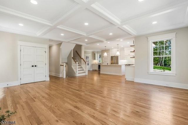 unfurnished living room with beam ceiling, light hardwood / wood-style flooring, and coffered ceiling