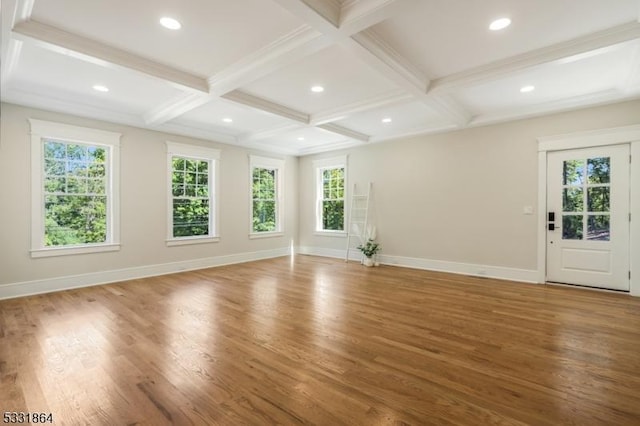 empty room with wood-type flooring, coffered ceiling, and beamed ceiling