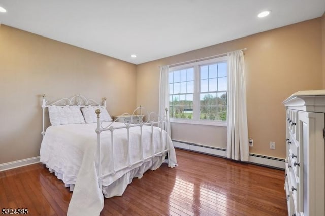 bedroom featuring dark wood-type flooring and a baseboard radiator