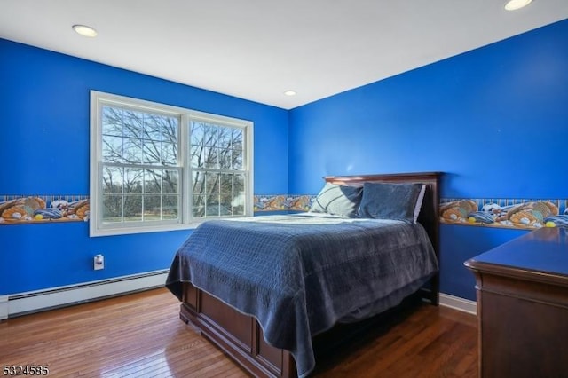 bedroom with hardwood / wood-style flooring and a baseboard radiator