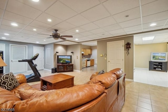 tiled living room featuring a drop ceiling and ceiling fan