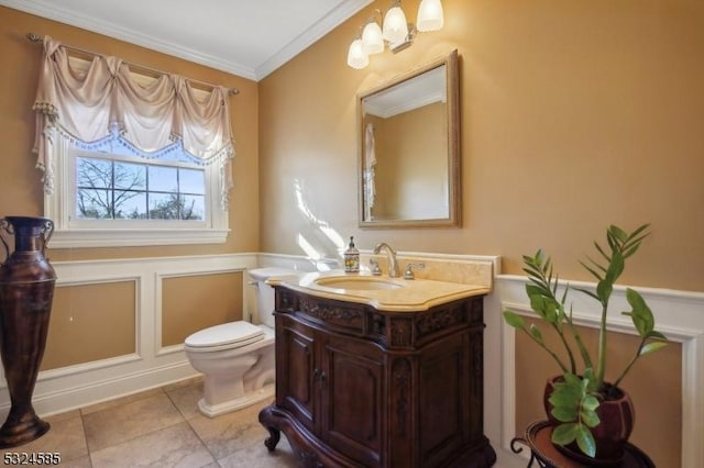 bathroom featuring tile patterned floors, vanity, toilet, and crown molding