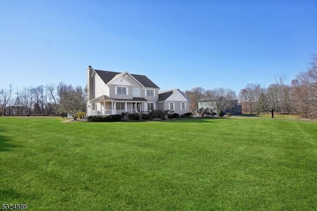 exterior space featuring covered porch and a front lawn