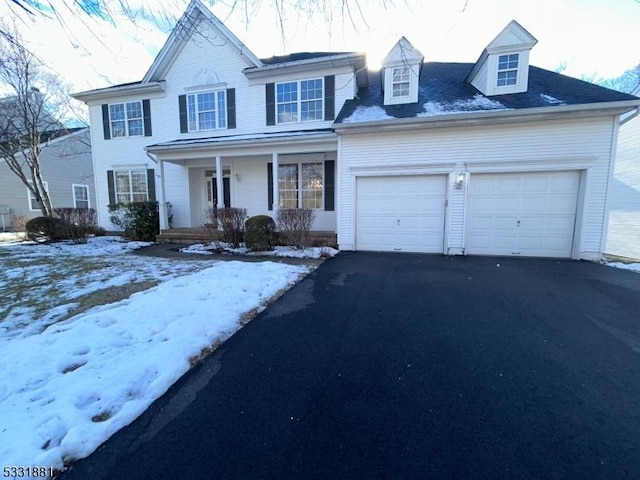 view of front of home featuring a porch and a garage