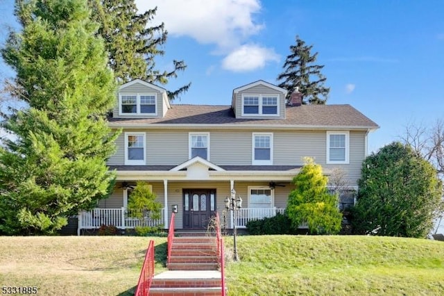 view of front facade with a front yard and a porch