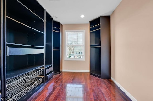 walk in closet featuring dark hardwood / wood-style floors