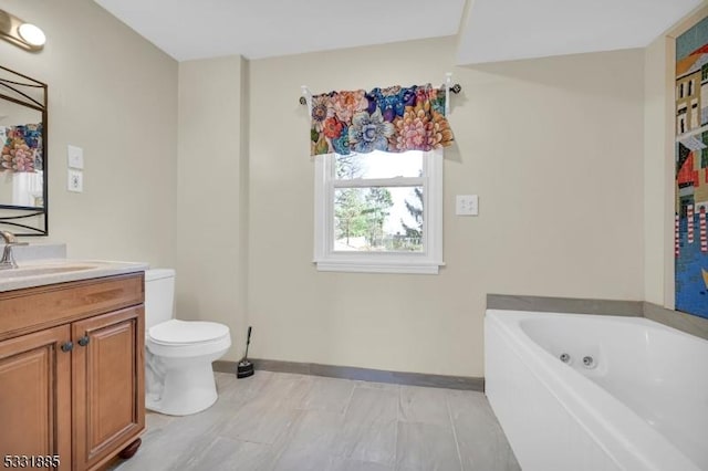 bathroom with a tub, vanity, and toilet