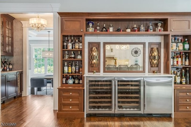 bar featuring crown molding, beverage cooler, and dark wood-type flooring