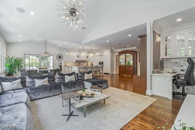 living room with dark hardwood / wood-style flooring, a chandelier, and lofted ceiling