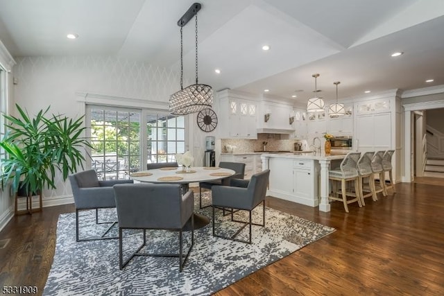 dining space with dark hardwood / wood-style flooring and lofted ceiling