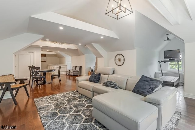 living room with an inviting chandelier, wood-type flooring, and vaulted ceiling