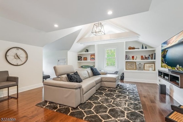 living room featuring dark hardwood / wood-style flooring, built in features, and lofted ceiling