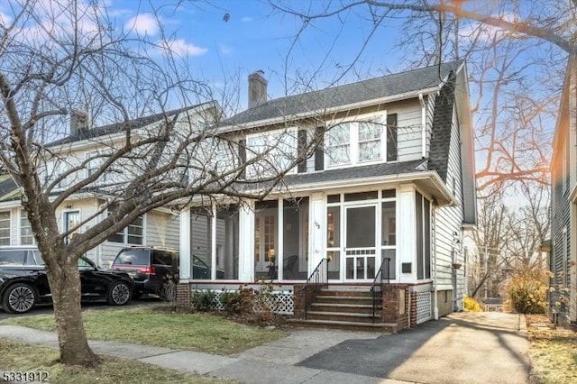 view of front facade with a sunroom