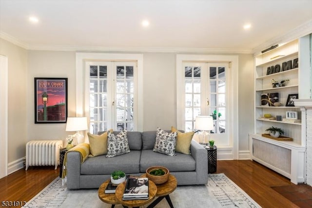 living room with radiator, french doors, crown molding, and dark hardwood / wood-style floors