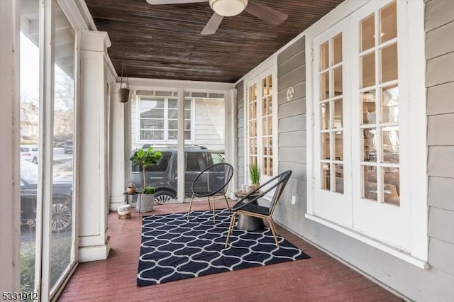 sunroom / solarium with ceiling fan and wood ceiling