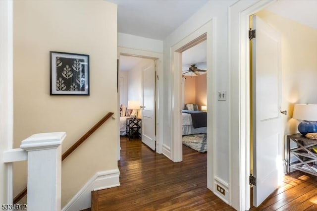 hallway with dark hardwood / wood-style flooring