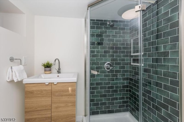 bathroom with vanity and a shower with shower door