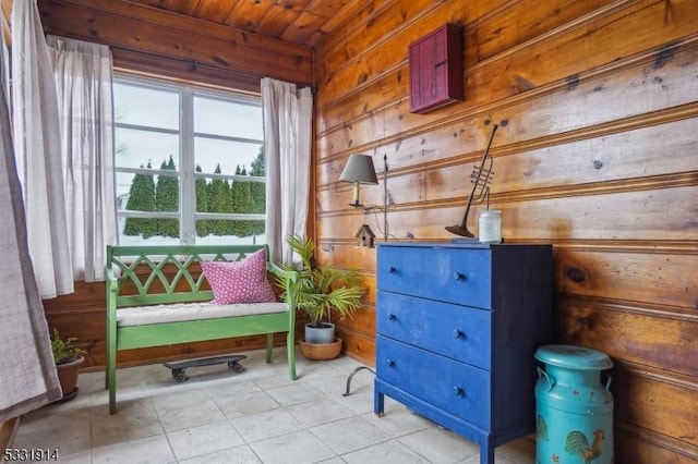 living area with wood ceiling and wooden walls