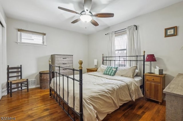 bedroom featuring ceiling fan and dark wood-type flooring