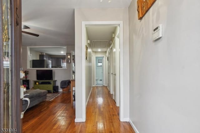 corridor with hardwood / wood-style floors