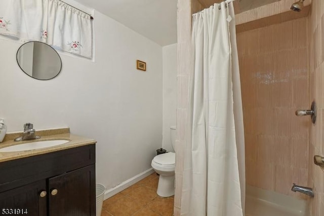 bathroom featuring toilet, vanity, and tile patterned flooring