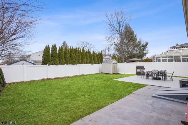 view of yard featuring a storage unit and a patio