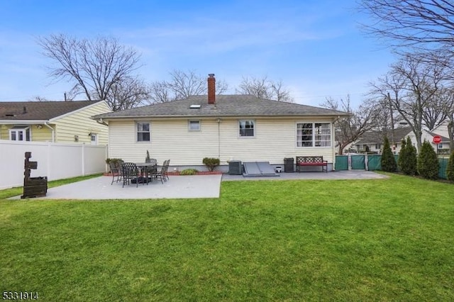 back of property with a patio area, a yard, and central air condition unit