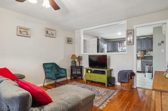 living room featuring ceiling fan and hardwood / wood-style floors