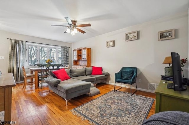 living room with ceiling fan and hardwood / wood-style flooring