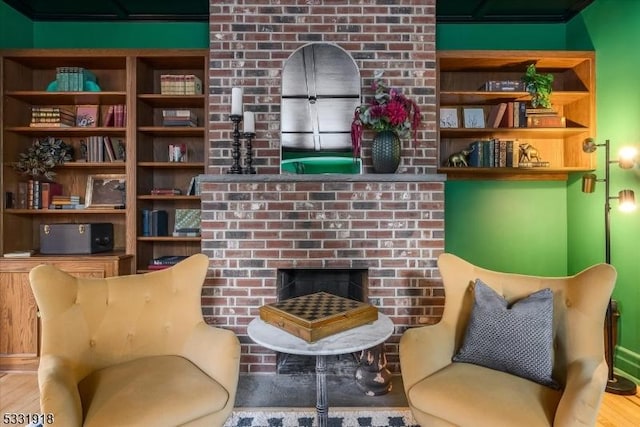 sitting room with a brick fireplace