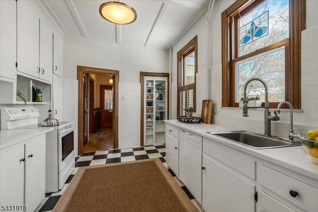 kitchen with white cabinetry, sink, and white appliances