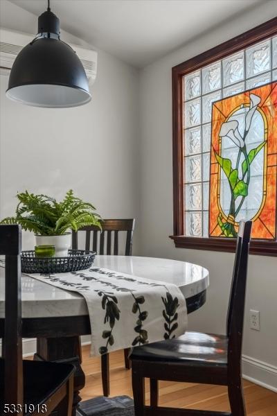 dining space with hardwood / wood-style flooring