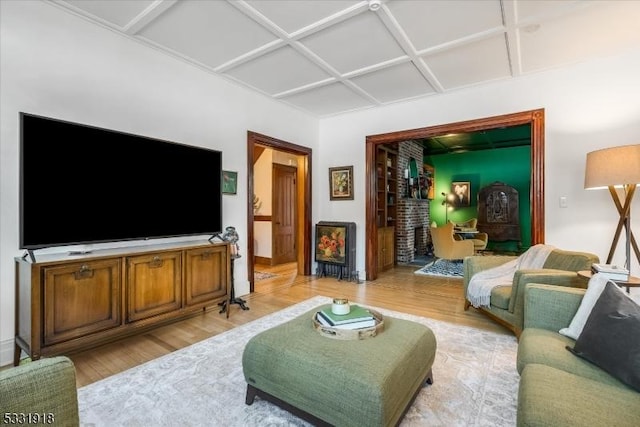 living room featuring light wood-type flooring and coffered ceiling