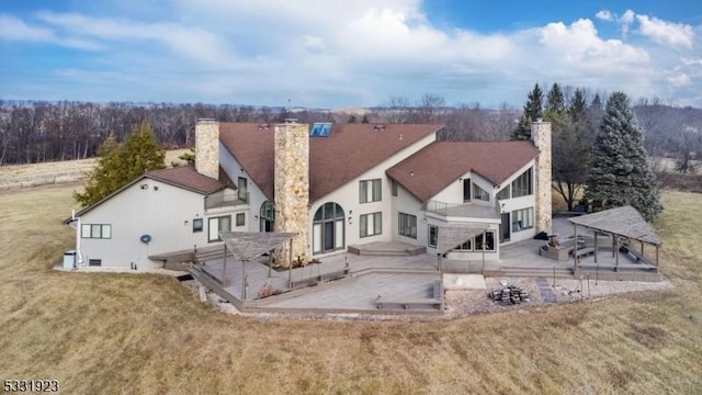 rear view of property with a yard and a patio