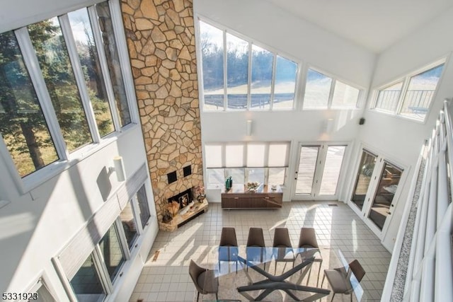 sunroom / solarium featuring a stone fireplace